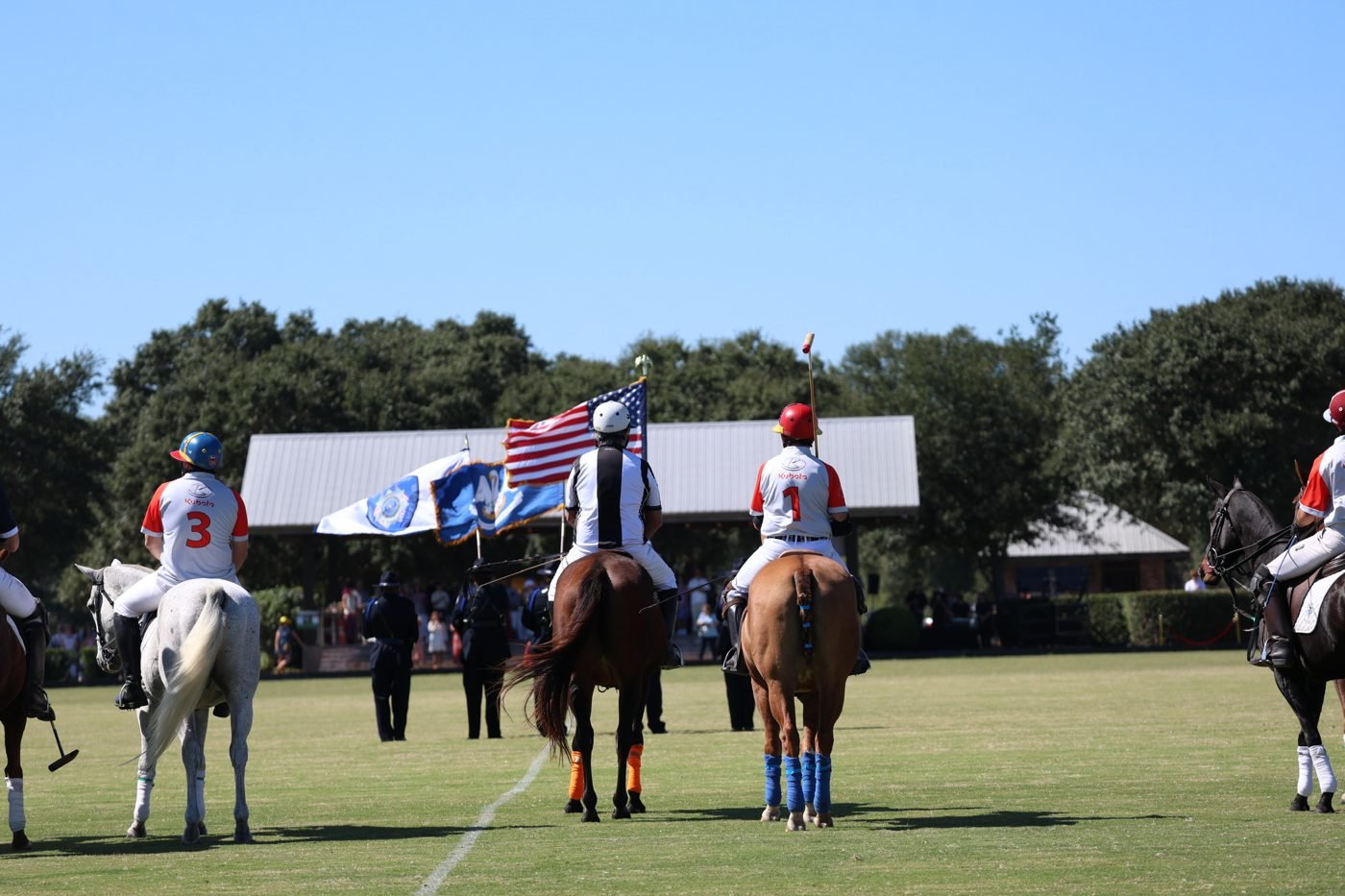 Riders and American flag before a match at New Orleans Polo Club